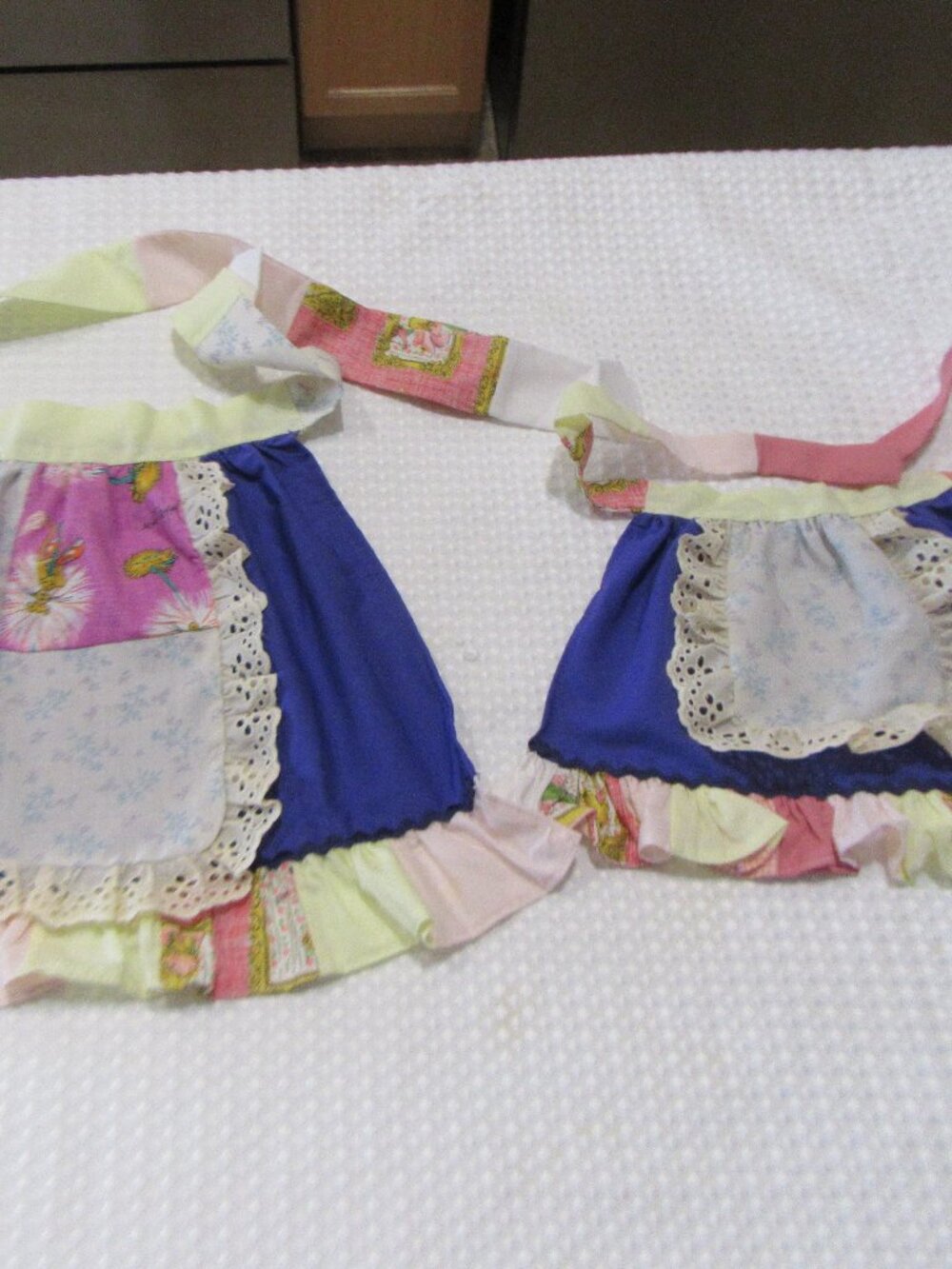 2 Hand Made Aprons 1 for a child and 1 for a doll Selling together